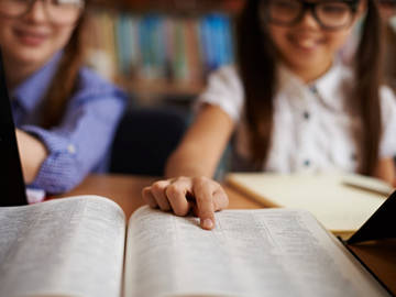 girl pointing to dictionary entry